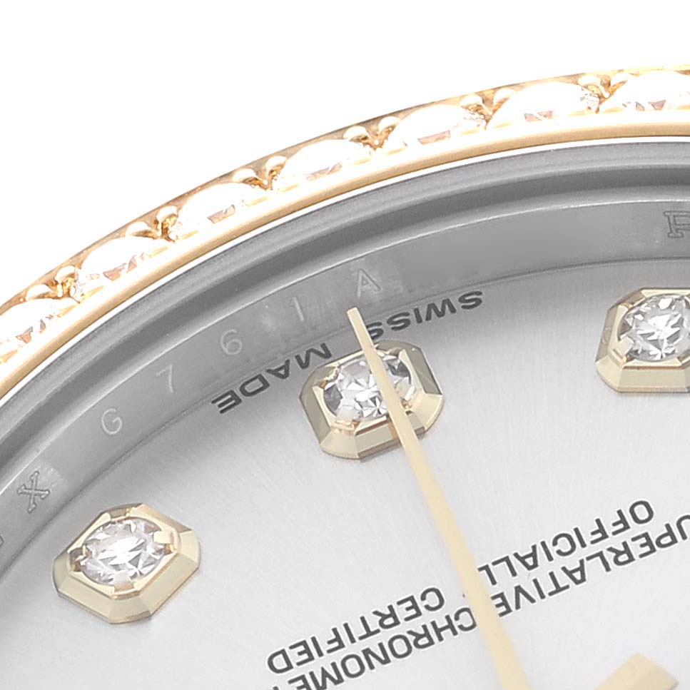 The image shows a close-up of a Rolex Mid-Size 178383 Women
s Steel and Gold (two tone) Silver Dial watch dial, featuring diamond hour markers and part of the bezel.