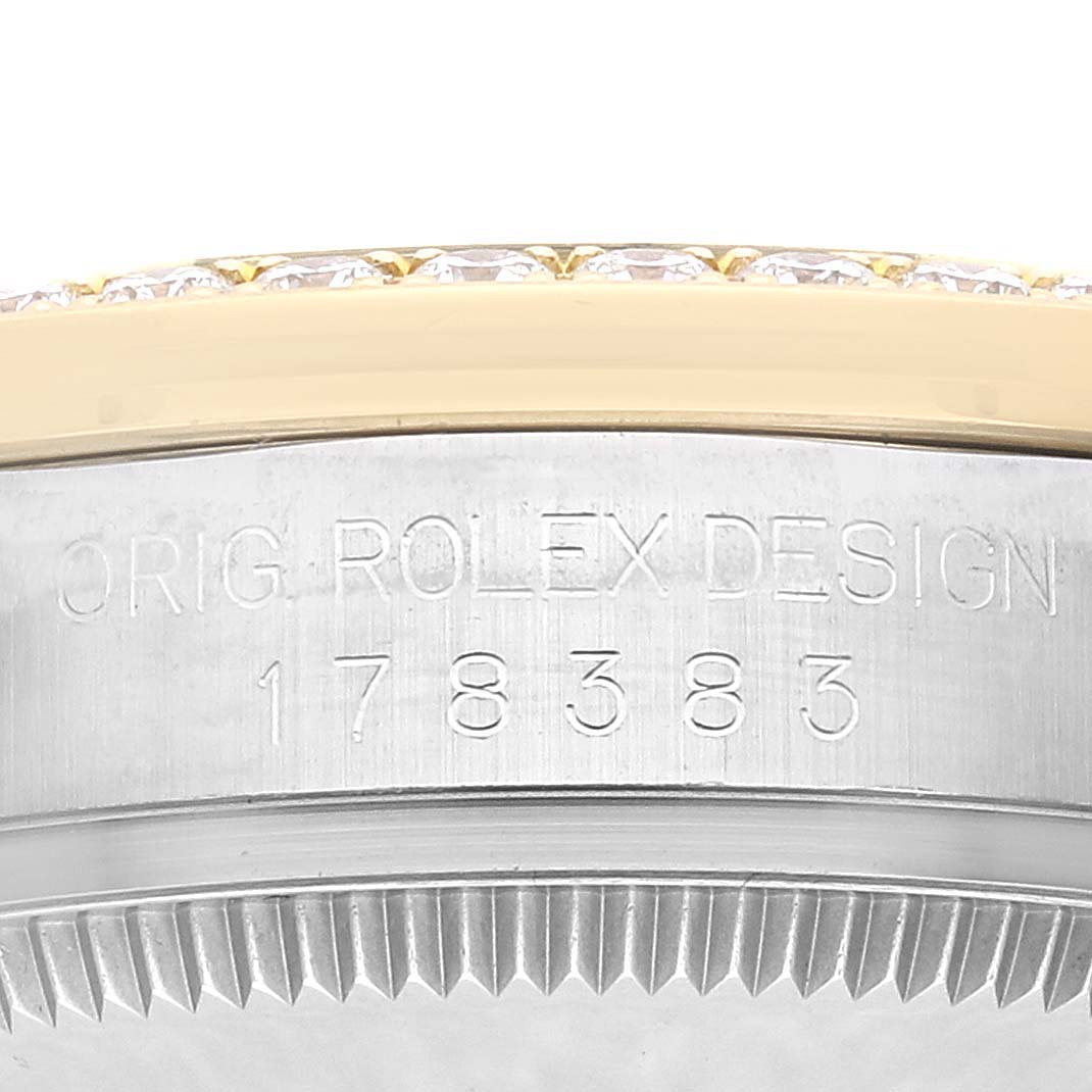 The image shows a close-up of the side of a Mid-Size Rolex watch case, highlighting the engravings and part of the bezel.