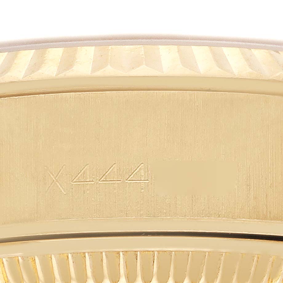 The image shows a close-up of the engraved side and fluted bezel of a Rolex President 69178 Women's Yellow Gold White Dial 69178 Women's Yellow Gold White Dial watch.