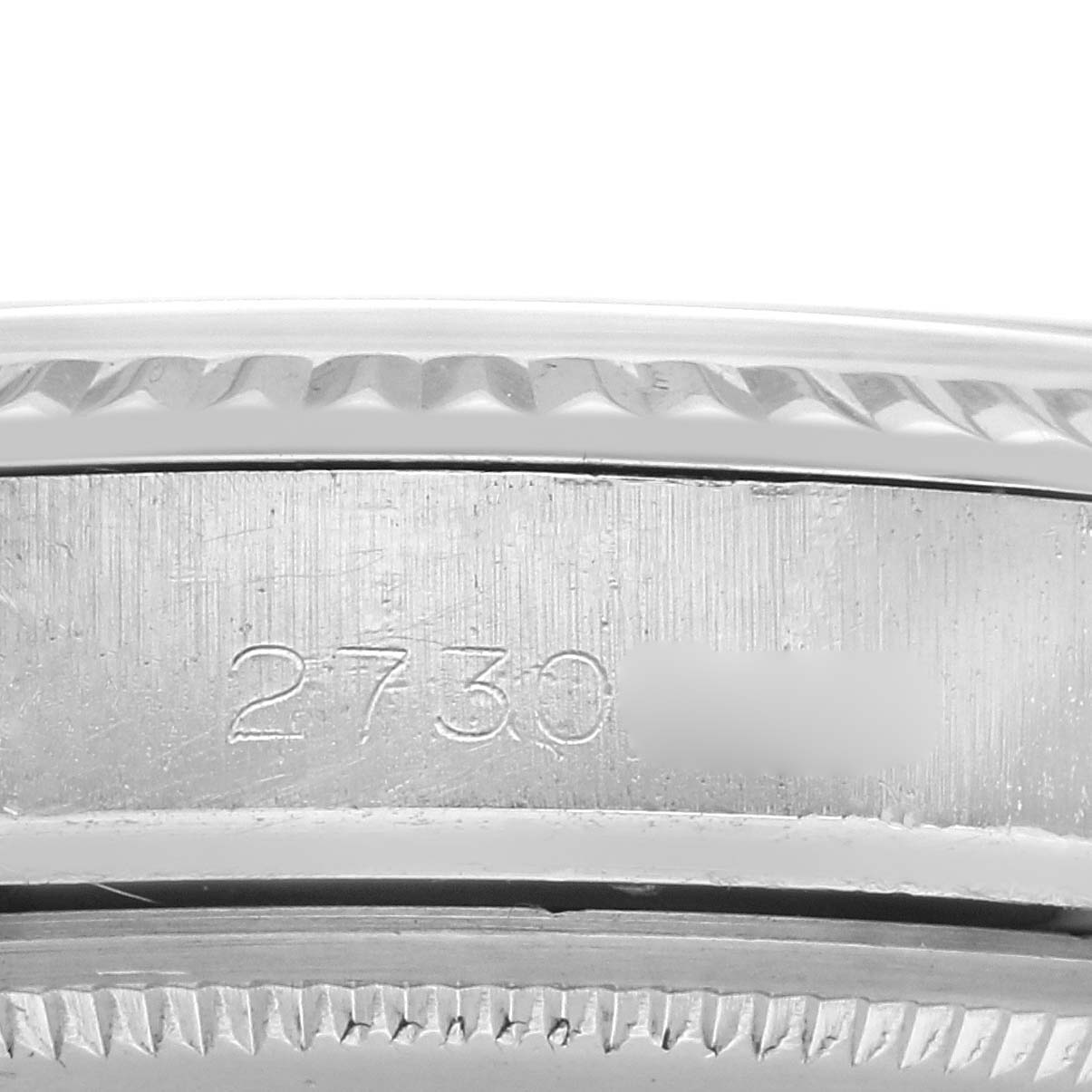 The image shows a close-up of the side of a Rolex Vintage Collection 1603 Men's Stainless Steel Silver Dial 1603 Men's Stainless Steel Silver Dial watch, focusing on the engraved serial number.