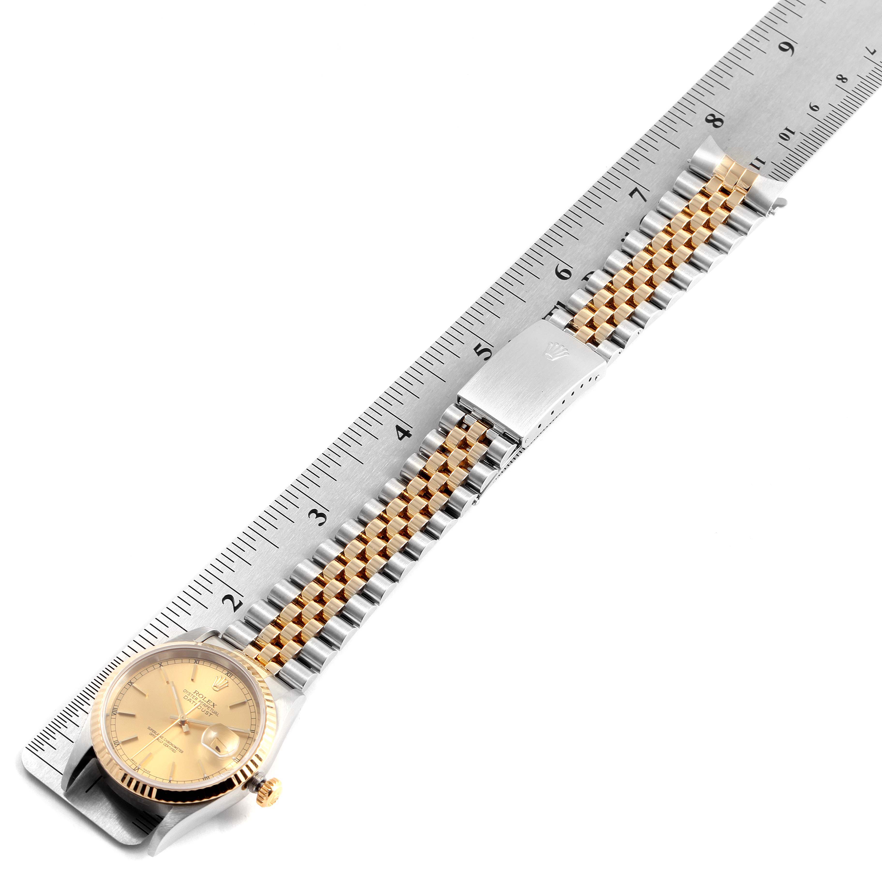 The image shows a Rolex Datejust 16233 Men's Steel and Gold (two tone) Champagne Dial 16233 Men's Steel and Gold (two tone) Champagne Dial watch with a gold face and a two-tone bracelet, laid flat next to a ruler.