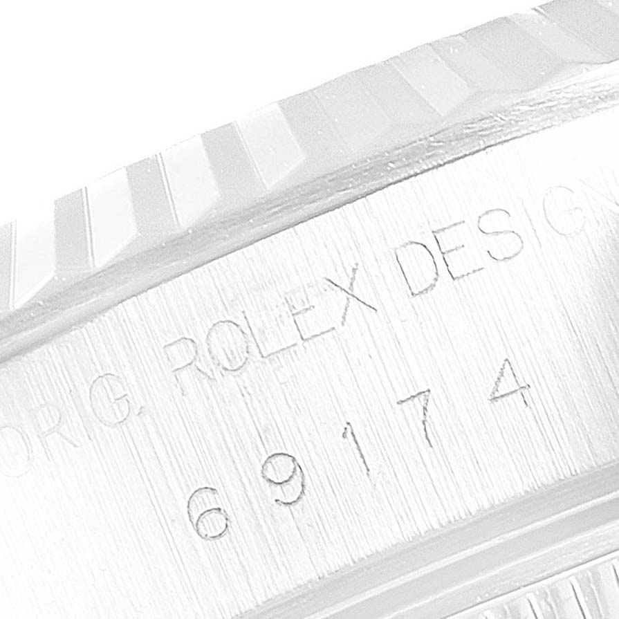 This close-up image shows the engraved side of the bezel and caseback of a Rolex Datejust 69174 Women's Stainless Steel Blue Dial 69174 Women's Stainless Steel Blue Dial watch.