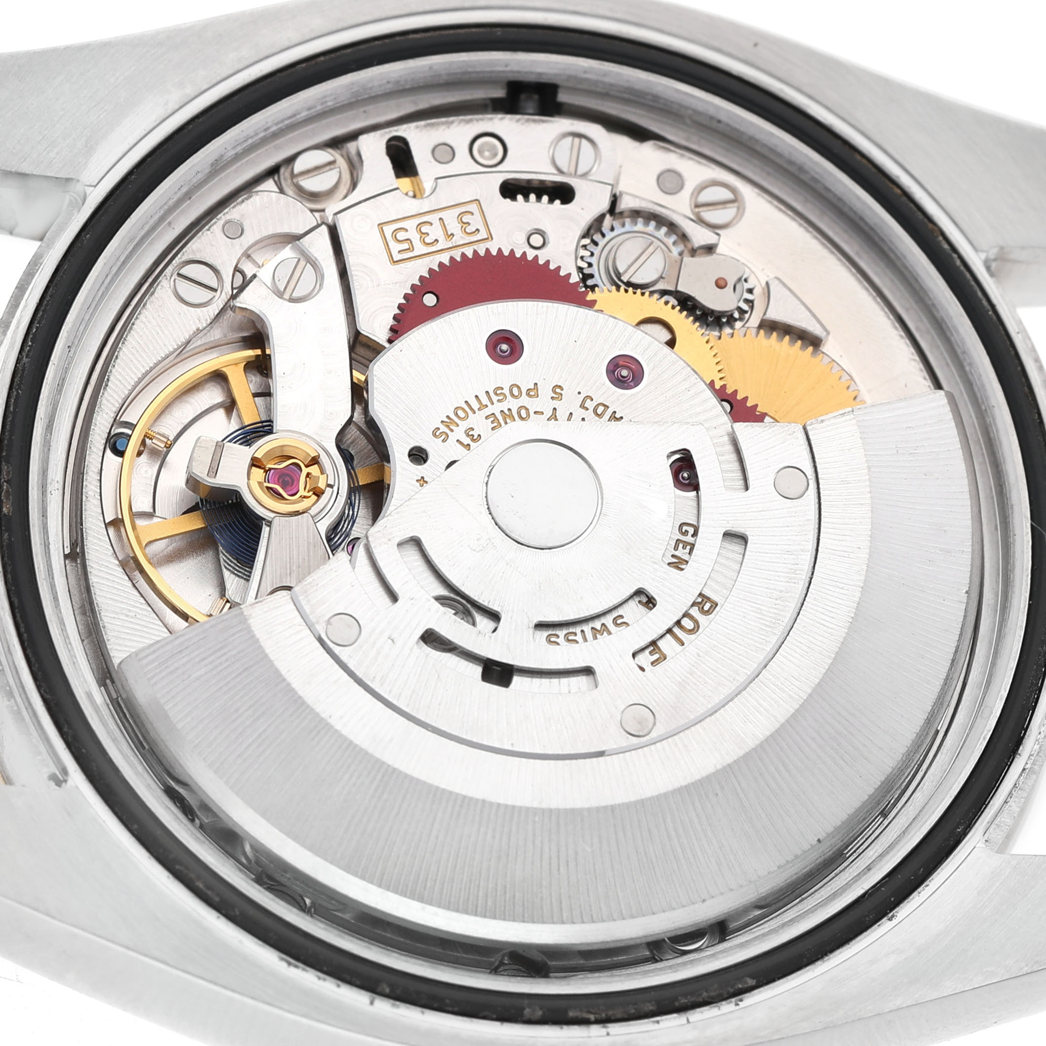 The image shows the internal movement of a Rolex Datejust 116243 Men's Steel and Gold (two tone) Silver Dial, highlighting gears and the escapement mechanism.