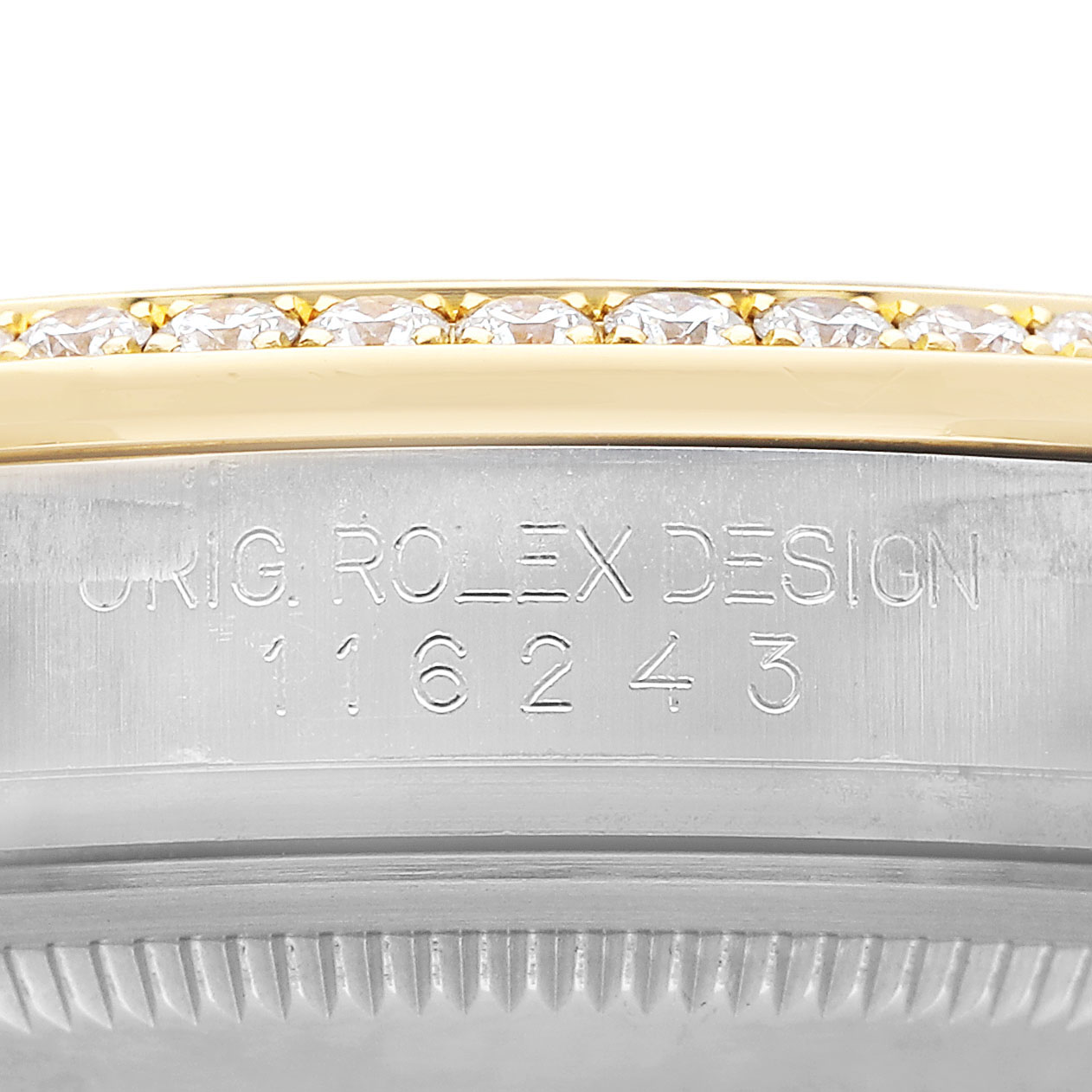 The image shows the engraved side and diamond bezel of a Rolex Datejust 116243 Men's Steel and Gold (two tone) Silver Dial watch from a close-up angle.