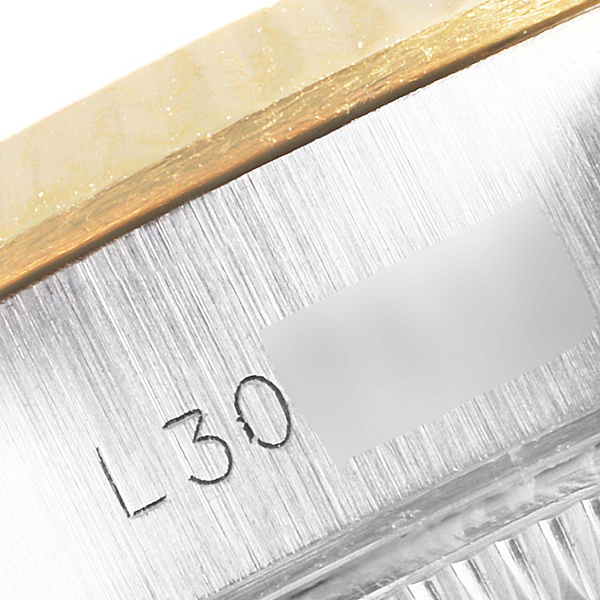 This image shows a close-up of the engraved reference details on the side of the Rolex Datejust 69173 Women's Steel and Gold (two tone) Silver Dial 69173 Women's Steel and Gold (two tone) Silver Dial watch case.