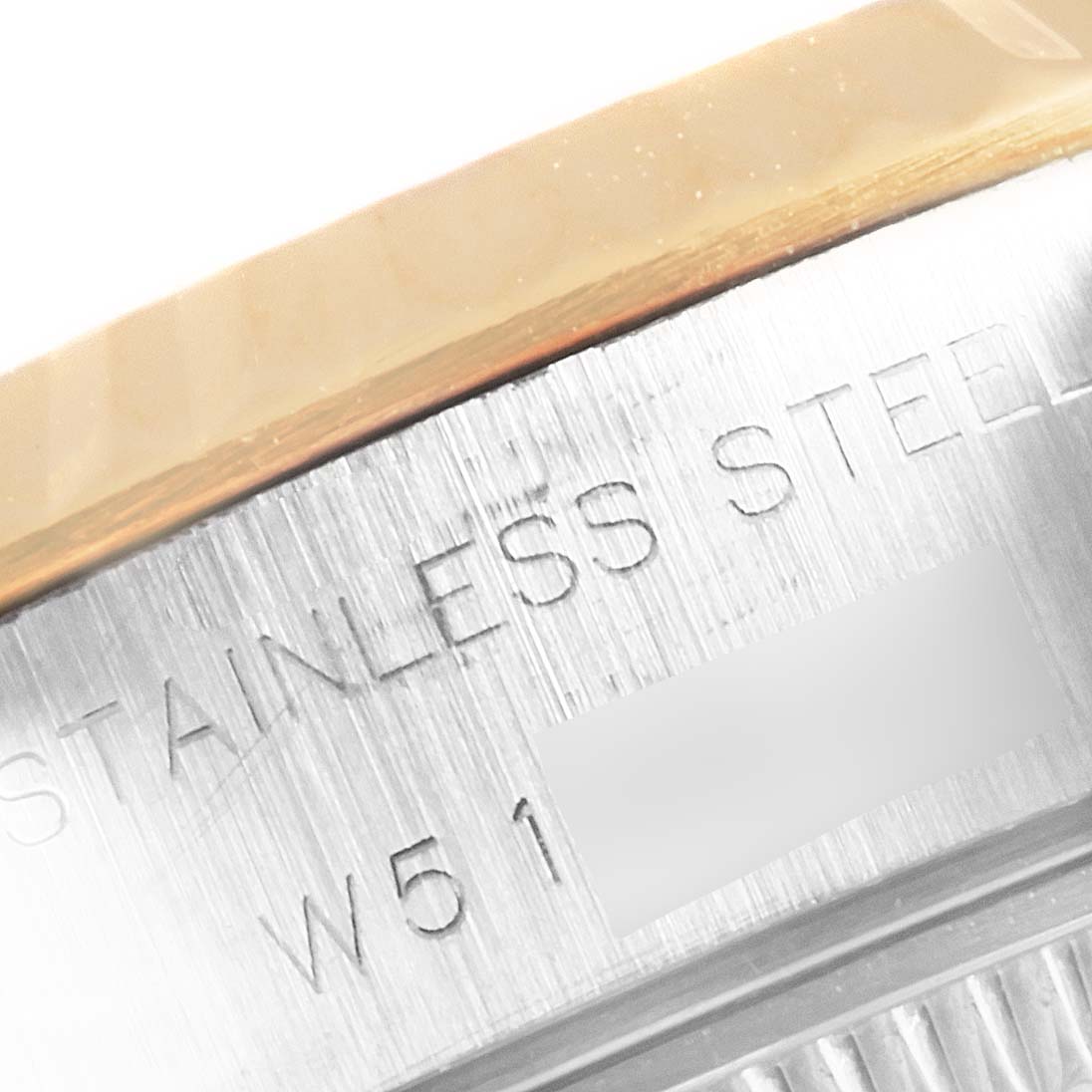 This close-up image shows the edge of the stainless steel case of a Rolex Datejust 69173 Women's Steel and Gold (two tone) Silver Dial 69173 Women's Steel and Gold (two tone) Silver Dial watch.