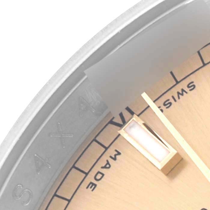 This image shows a partial close-up of the Rolex Datejust 116233 Men
s Steel and Gold (two tone) Champagne Dial 116233 Men
s Steel and Gold (two tone) Champagne Dial dial, hands, and bezel edge.