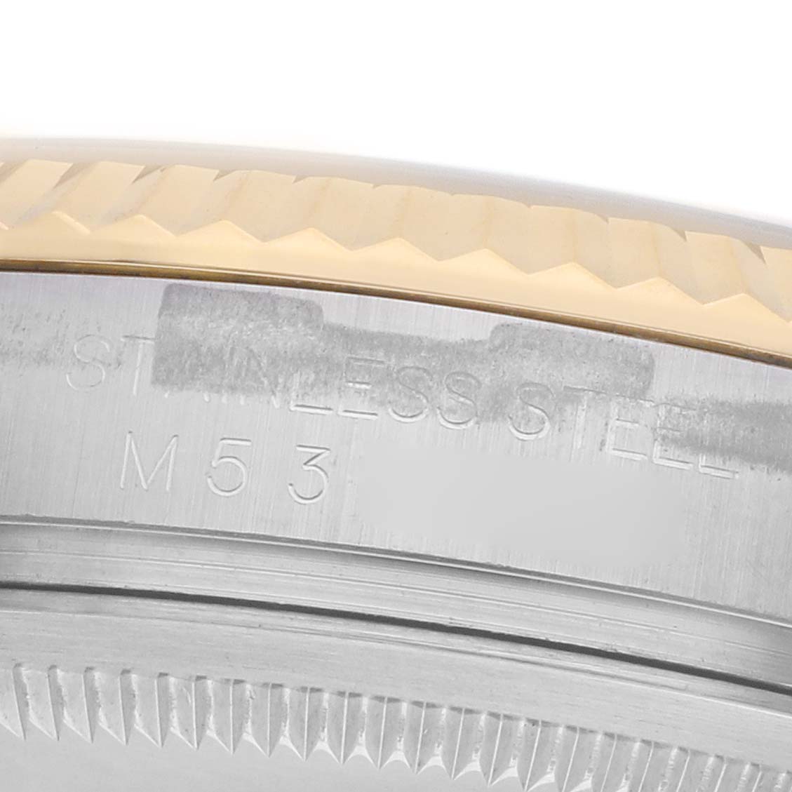 The image shows a close-up of the side edge, bezel, and engraved serial number of a Rolex Datejust 116233 Men
s Steel and Gold (two tone) Silver Dial watch.