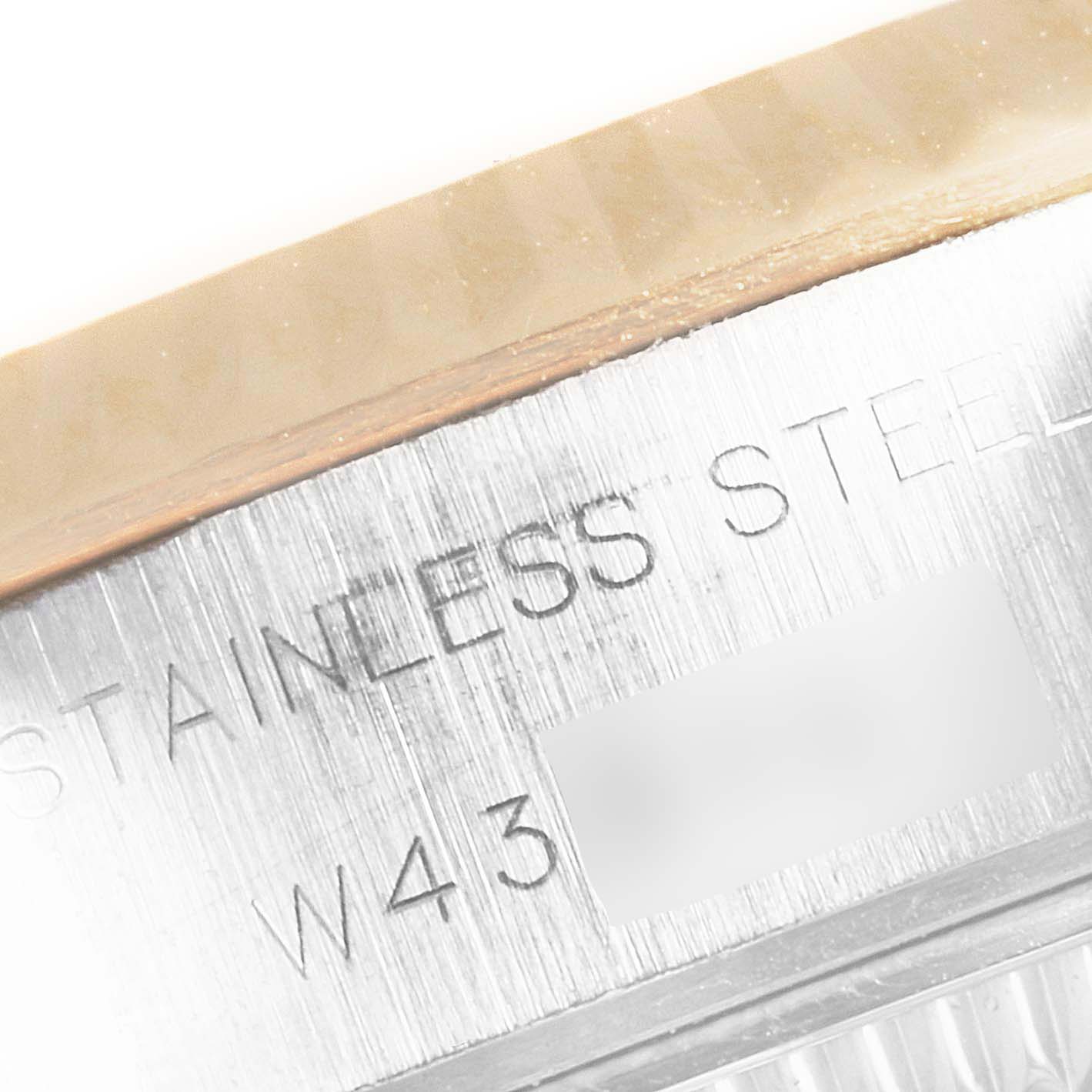 This close-up image of a Rolex Datejust 69173 Women's Steel and Gold (two tone) White Dial 69173 Women's Steel and Gold (two tone) White Dial shows the side of the stainless steel case with engraving.