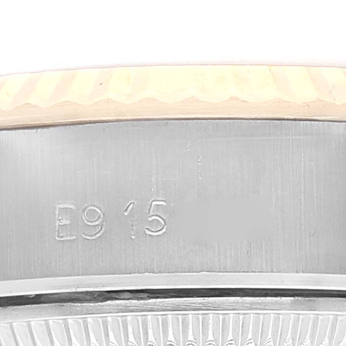 This image shows a close-up of the serial number and part of the bezel on a Rolex Datejust 69173 Women's Steel and Gold (two tone) Champagne Dial 69173 Women's Steel and Gold (two tone) Champagne Dial watch.