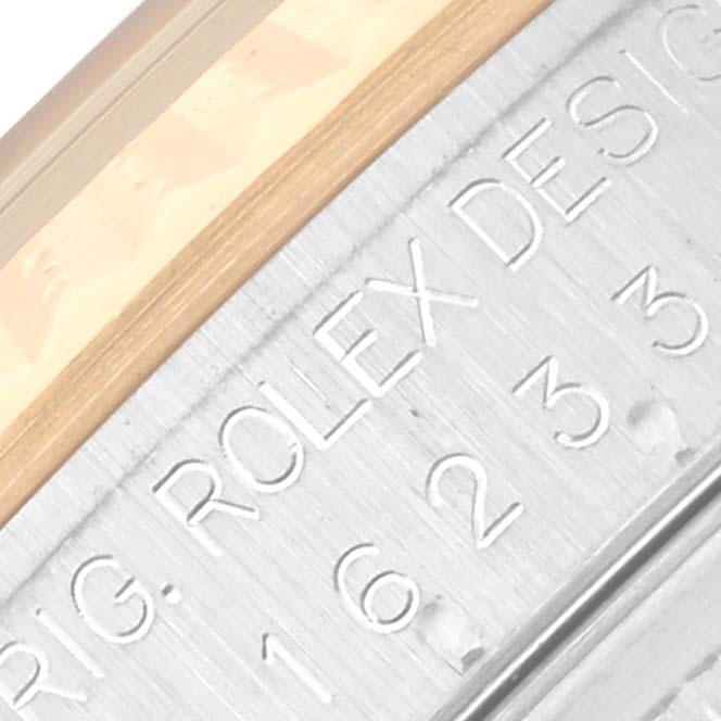The image shows a close-up of the side engraving on a Rolex Datejust 16233 Men
s Steel and Gold (two tone) White Dial 16233 Men
s Steel and Gold (two tone) White Dial, highlighting the brand and model number.