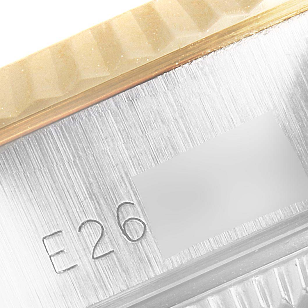 The image shows a close-up view of the serial number engraving and fluted bezel on a Rolex Datejust 69173 Women's Steel and Gold (two tone) Silver Dial 69173 Women's Steel and Gold (two tone) Silver Dial watch.