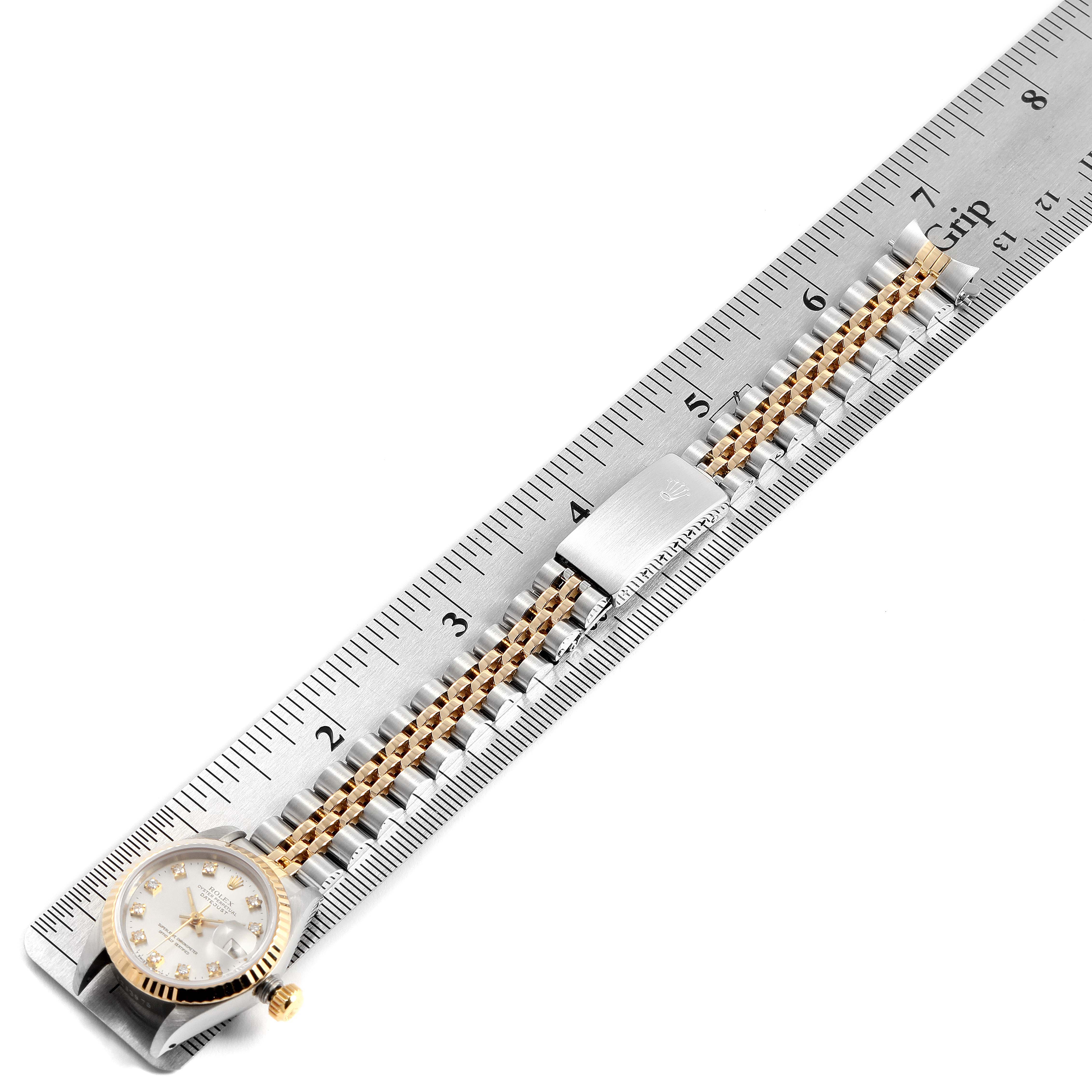 The image shows the Rolex Datejust 69173 Women's Steel and Gold (two tone) Silver Dial 69173 Women's Steel and Gold (two tone) Silver Dial watch laid flat, with its face and the full bracelet displayed on a ruler for measurement.