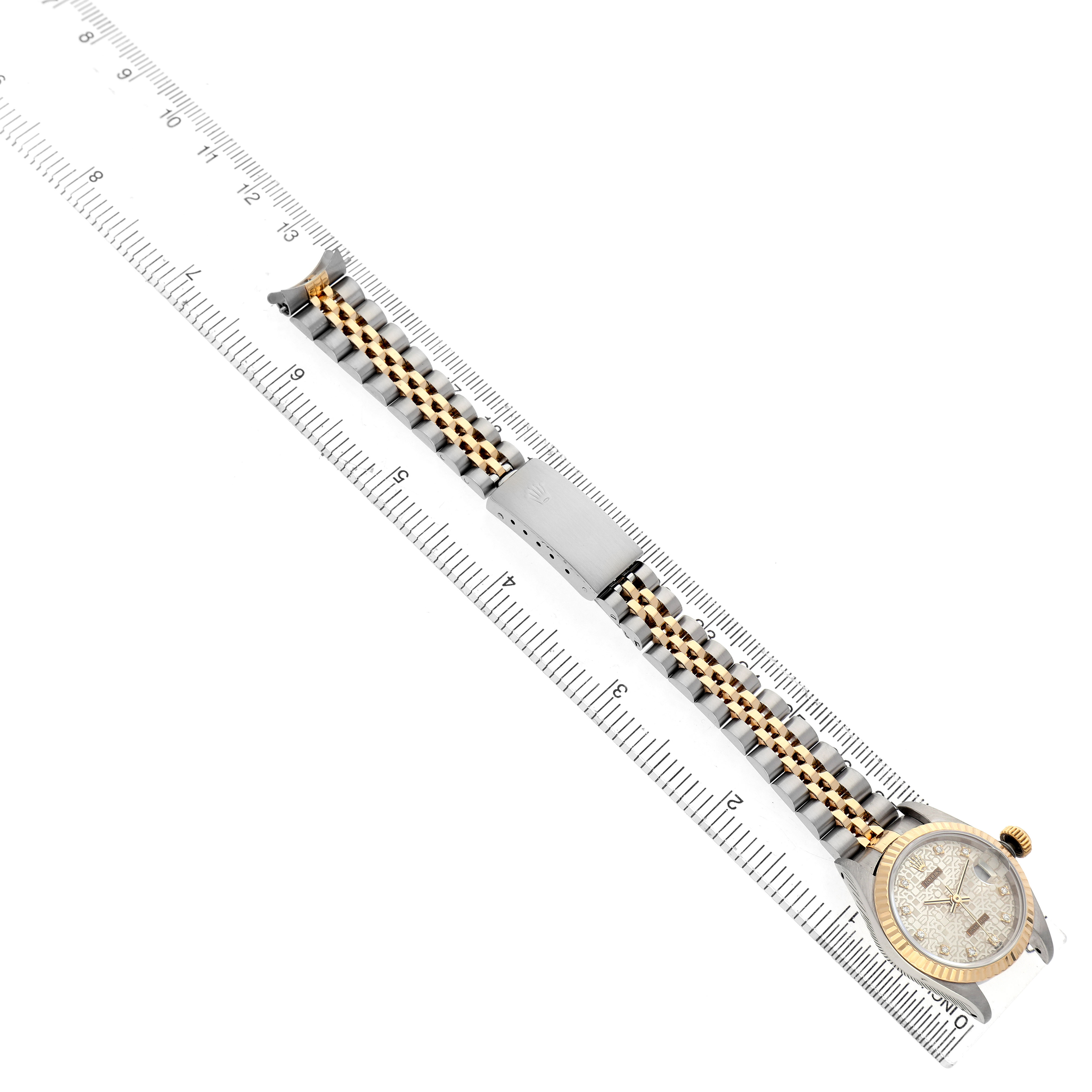 The Rolex Datejust 69173 Women's Steel and Gold (two tone) Silver Dial watch is displayed diagonally, showing the bracelet, clasp, and bezel alongside a ruler.