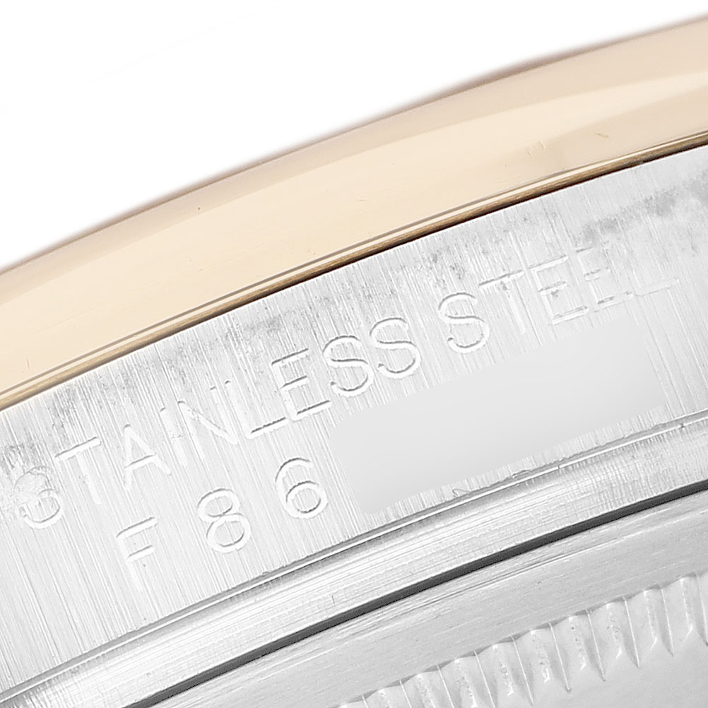 The image shows the edge of the case back of a Rolex Datejust 116203 Men's Steel and Gold (two tone) Grey Dial, highlighting the stainless steel and serial engraving.