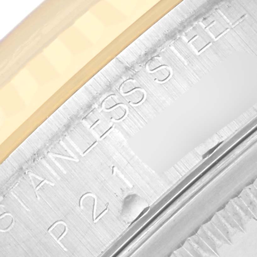 The image shows a close-up of the Rolex Datejust 16233 Men's Steel and Gold (two tone) Blue Dial 16233 Men's Steel and Gold (two tone) Blue Dial watch bezel and engraved lettering on the case.