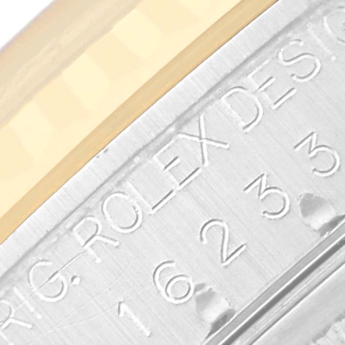 The image shows a close-up of the case side with engraving on a Rolex Datejust 16233 Men's Steel and Gold (two tone) Blue Dial 16233 Men's Steel and Gold (two tone) Blue Dial watch.