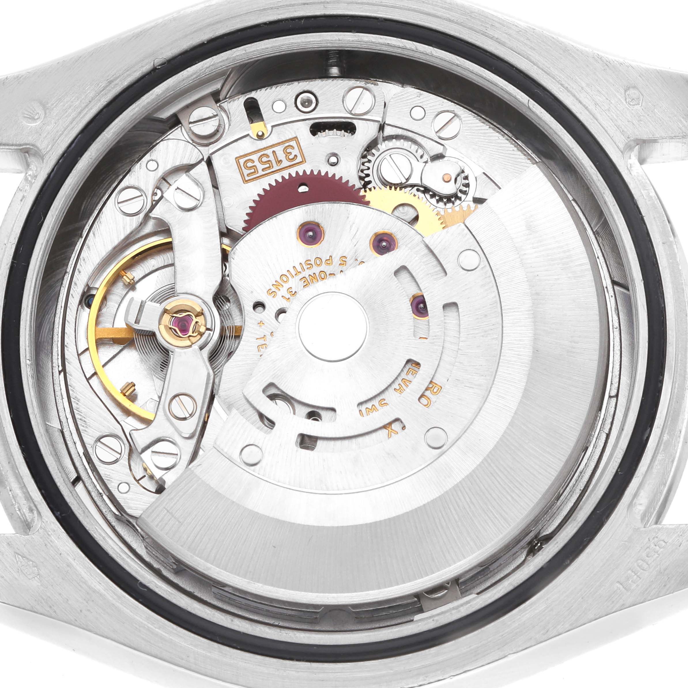 The image shows the movement of a Rolex Pearlmaster 18946 Men
s Platinum Silver Dial watch from a top-down view, highlighting gears and mechanical components.