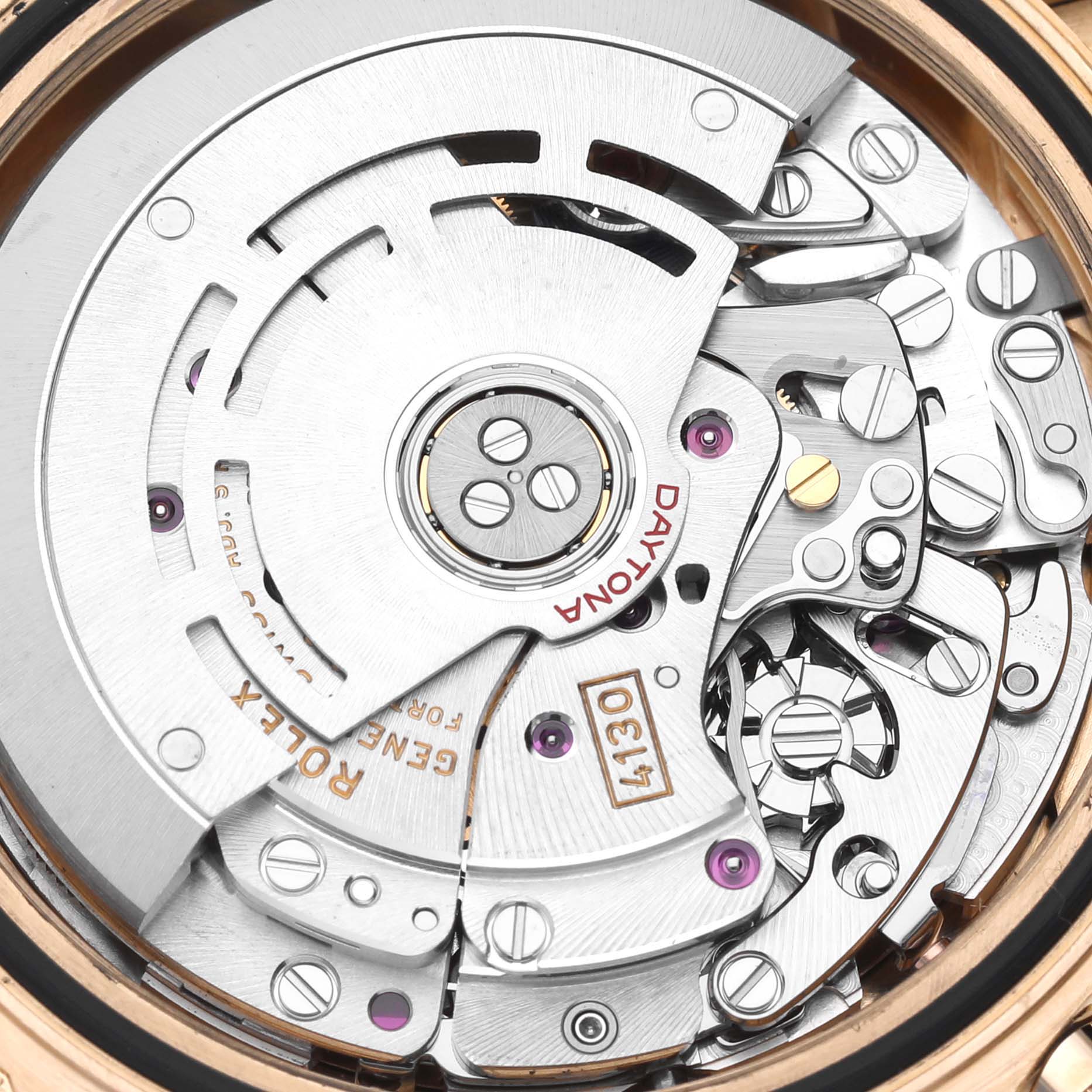 The image shows an angled close-up of the Rolex Daytona 116518LN Men's Yellow Gold Black Dial 116518LN Men's Yellow Gold Black Dial's intricate movement mechanism.