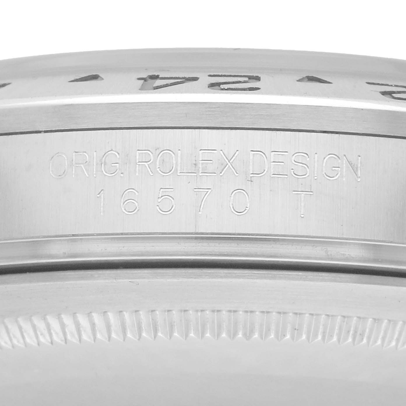 The image shows a close-up side view of the case edge of the Rolex Explorer 16570 Men
s Stainless Steel Black Dial, displaying the watch
s engraved design number.