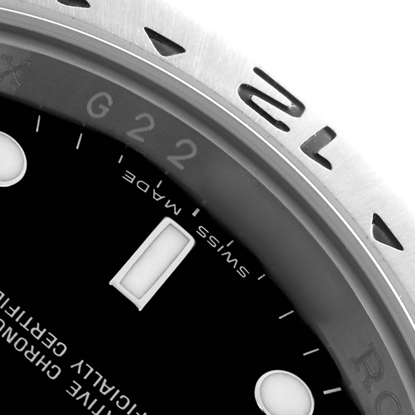 The image shows a close-up of the Rolex Explorer 16570 Men
s Stainless Steel Black Dial
s bezel and part of the dial, highlighting the "Swiss Made" text.