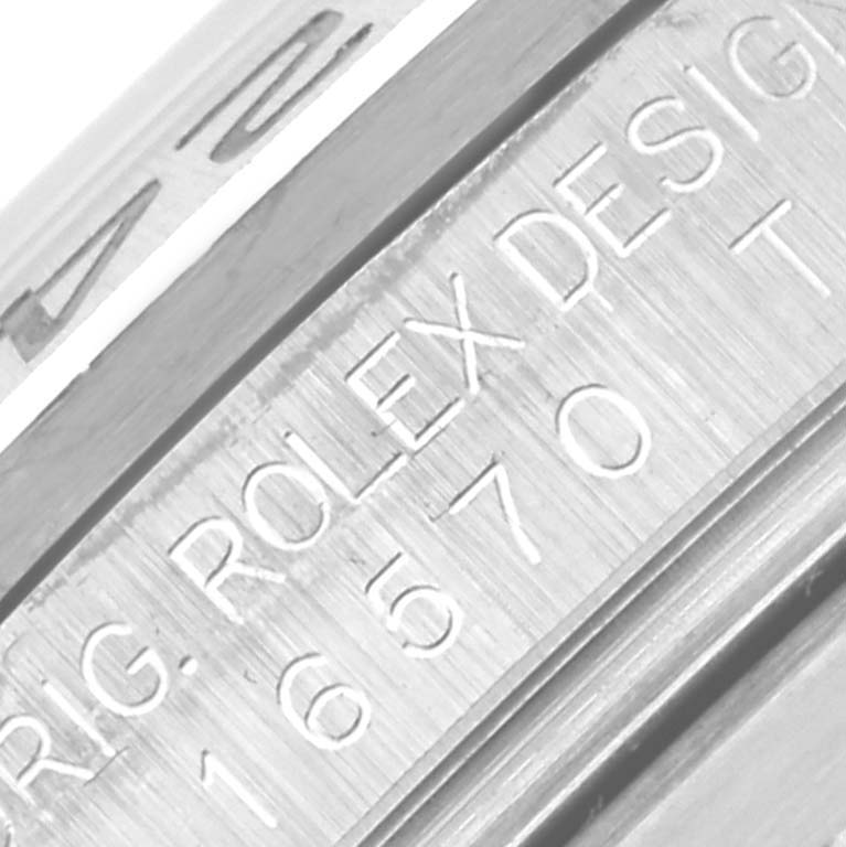 The image shows a close-up of the Rolex Explorer 16570 Men's Stainless Steel White Dial 16570 Men's Stainless Steel White Dial model's engraved case side, displaying "ORIG. ROLEX DESIGN 16570."