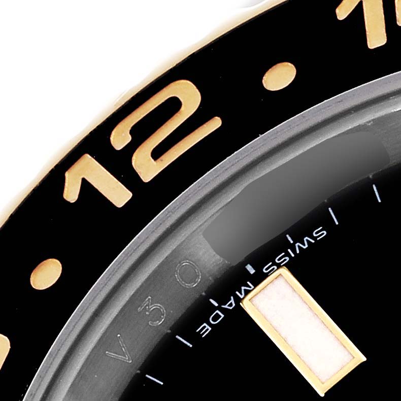 The image shows a close-up of the bezel and dial edge of a Rolex GMT-Master 116713 Men's Steel and Gold (two tone) Black Dial 116713 Men's Steel and Gold (two tone) Black Dial, displaying the number "12" and "Swiss Made."