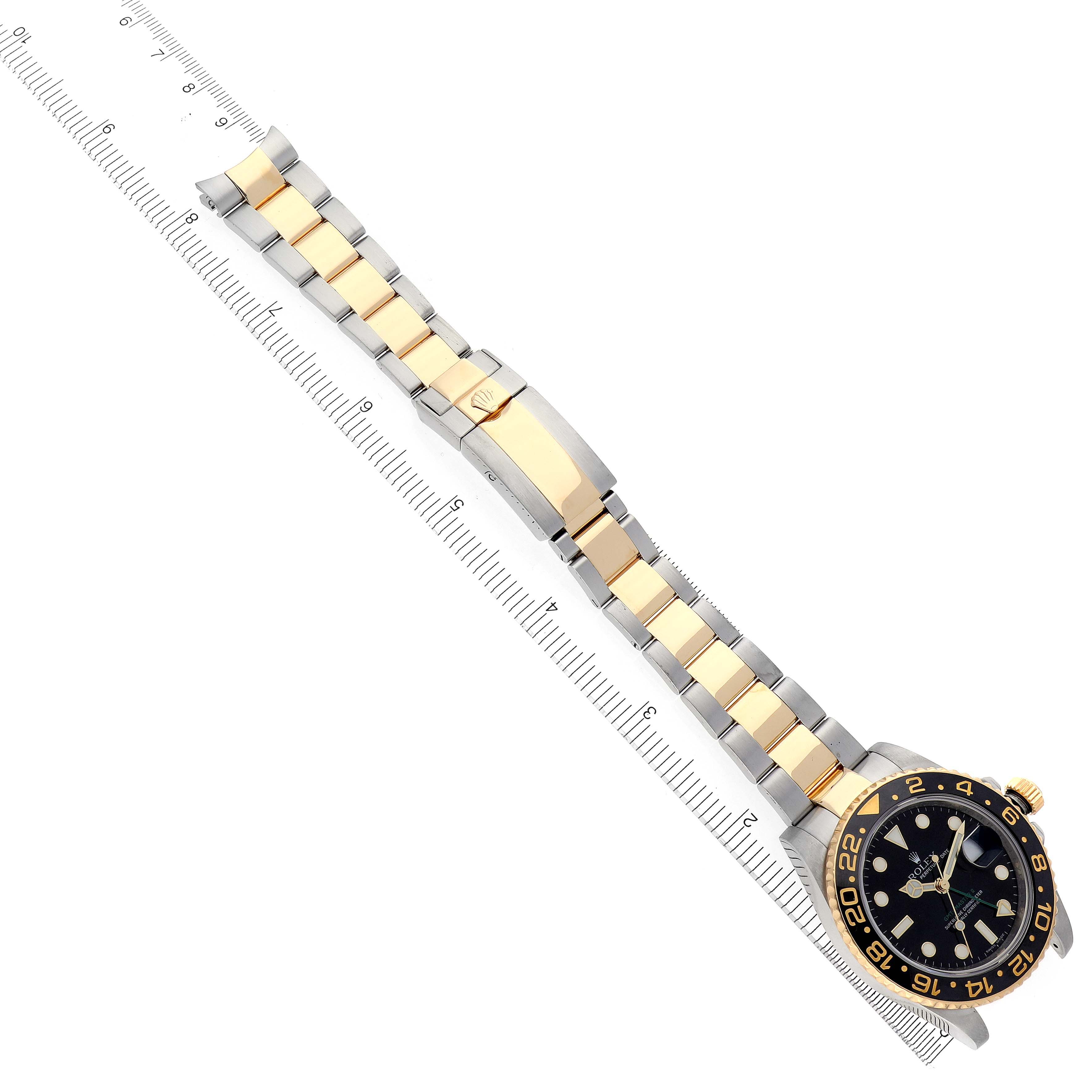 The Rolex GMT-Master 116713 Men's Steel and Gold (two tone) Black Dial 116713 Men's Steel and Gold (two tone) Black Dial watch is shown laid flat with the dial, bezel, bracelet, and clasp visible.