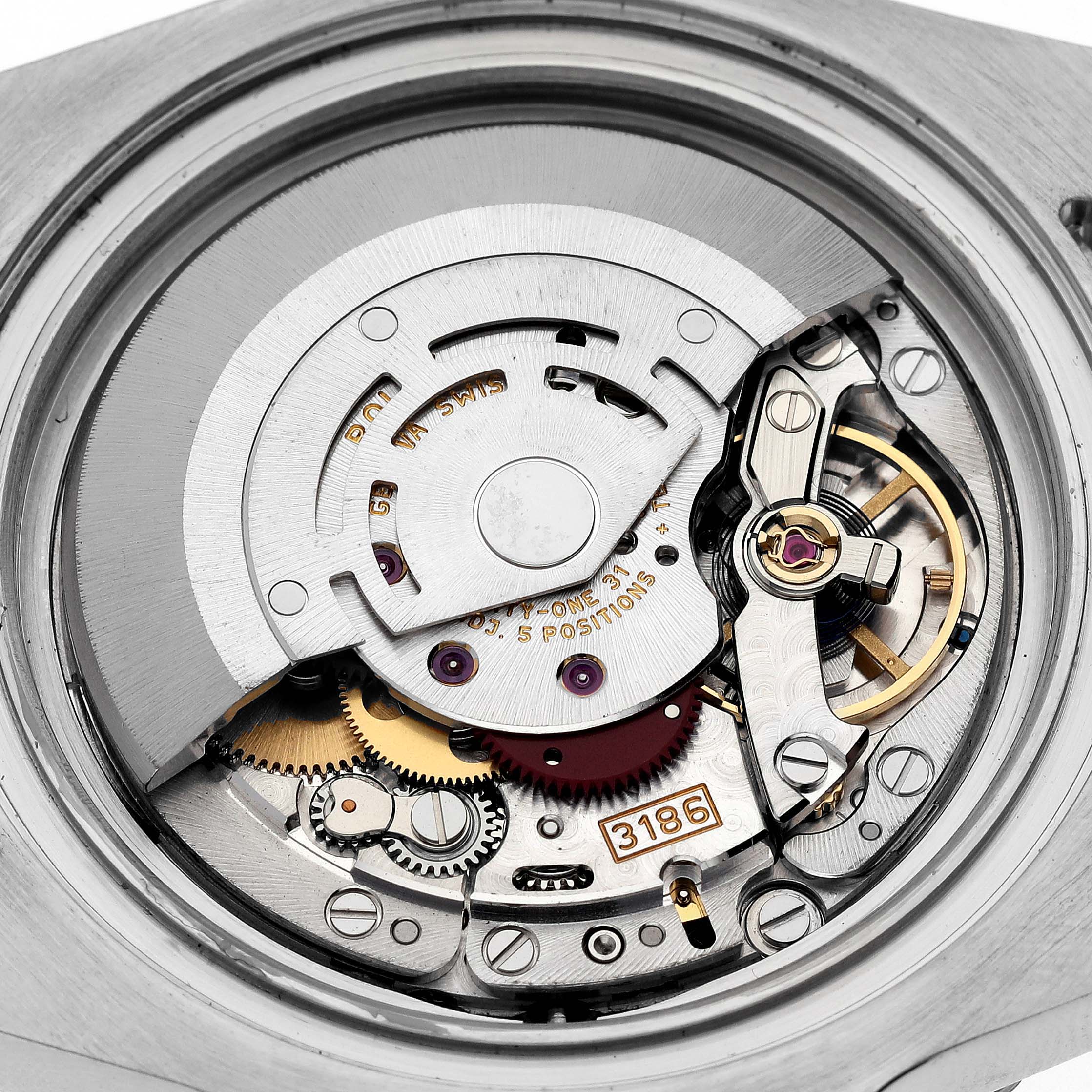 The image shows the movement of the Rolex GMT-Master 116713 Men's Steel and Gold (two tone) Black Dial 116713 Men's Steel and Gold (two tone) Black Dial, featuring gears, screws, and the rotor mechanism.