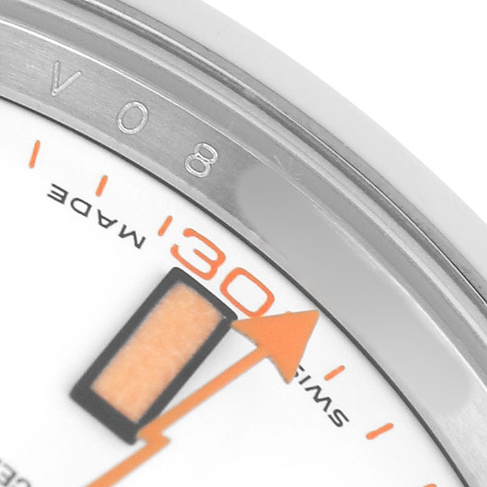 The image shows a close-up of a Rolex Milgauss 116400 Men's Stainless Steel White Dial watch face, highlighting the orange hand, minute markers, and part of the bezel.