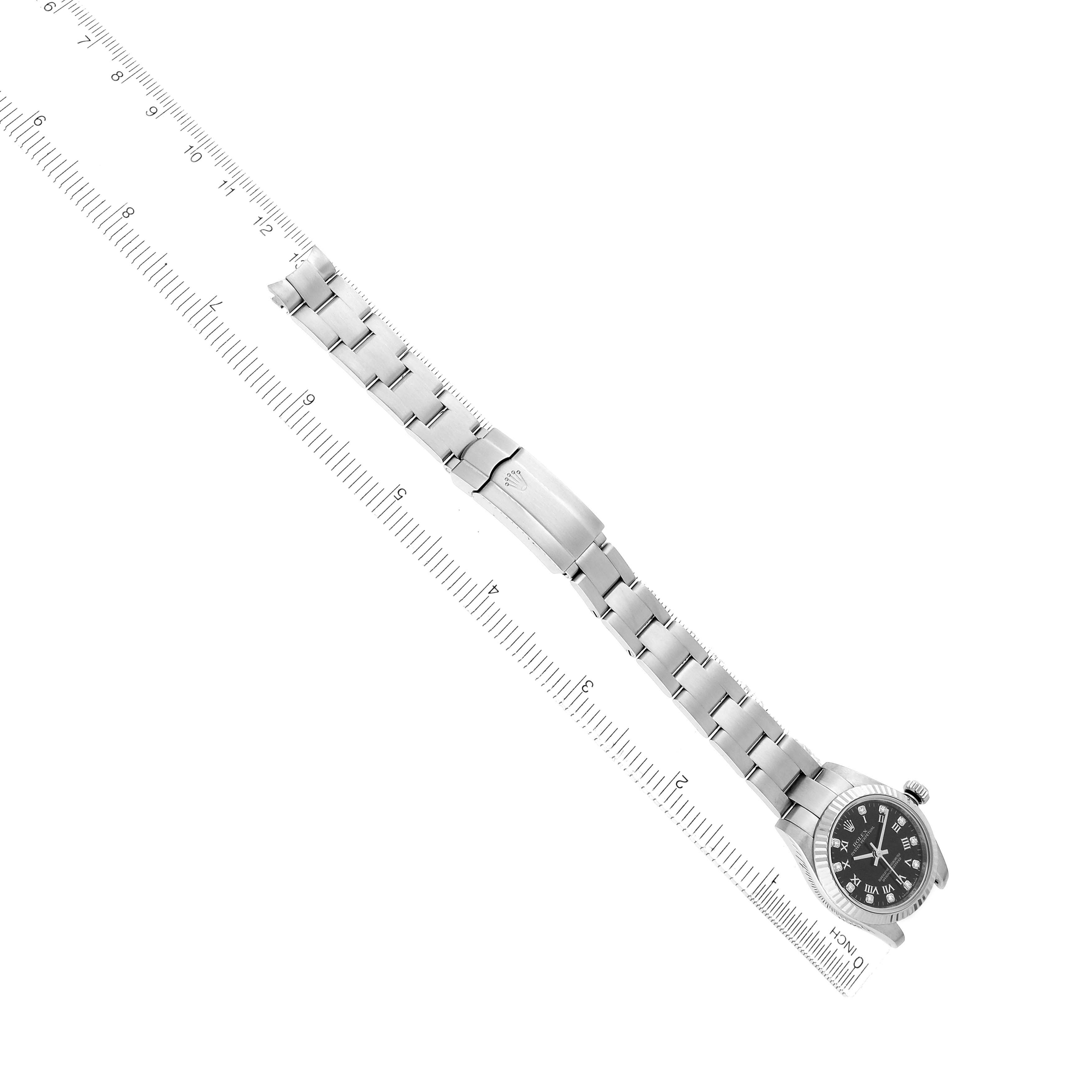 The Rolex Oyster Perpetual 176234 Women
s Stainless Steel Black Dial watch is shown at an angle displaying the full bracelet and face, alongside a measuring ruler.