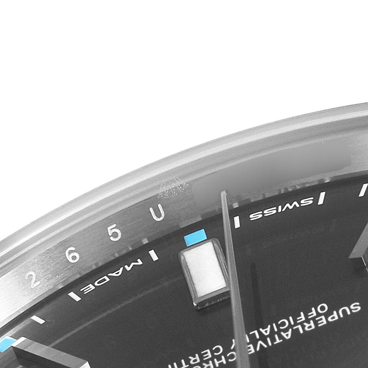 The image shows a close-up of the dial's edge and part of the minute hand of a Rolex Oyster Perpetual 114300 Men's Stainless Steel Silver Dial 114300 Men's Stainless Steel Silver Dial watch.