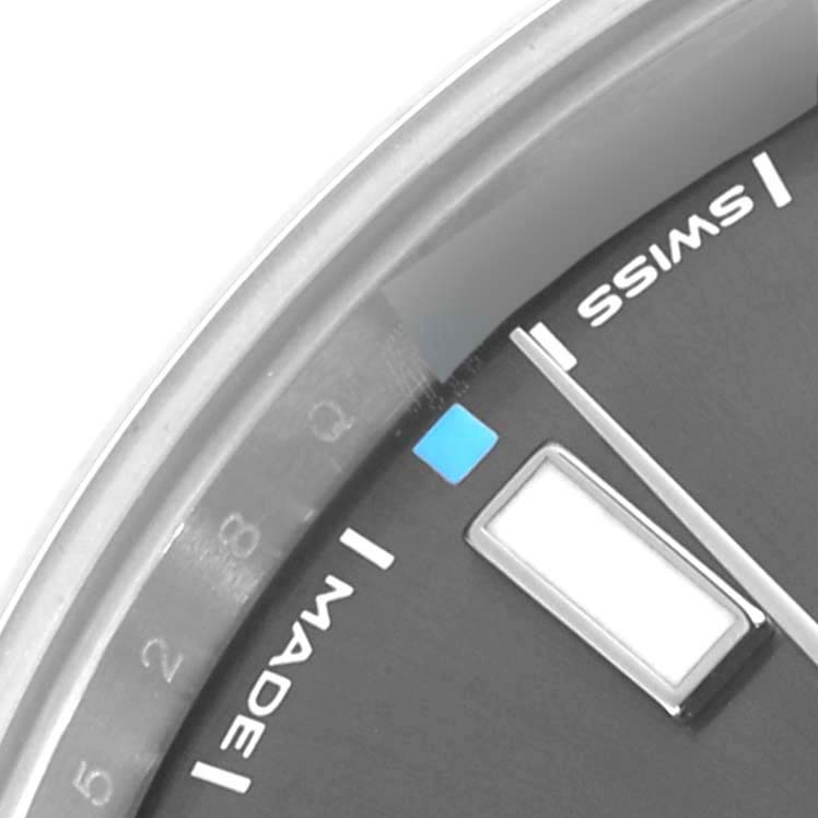 The image shows a close-up of the dial and bezel of a Rolex Oyster Perpetual 114300 Men's Stainless Steel Grey Dial 114300 Men's Stainless Steel Grey Dial, highlighting the "SWISS MADE" text.