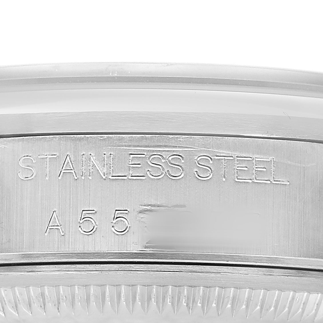 The image shows an engraved side of a Rolex Date 15200 Men's Stainless Steel Black Dial model watch, focusing on the stainless steel case.