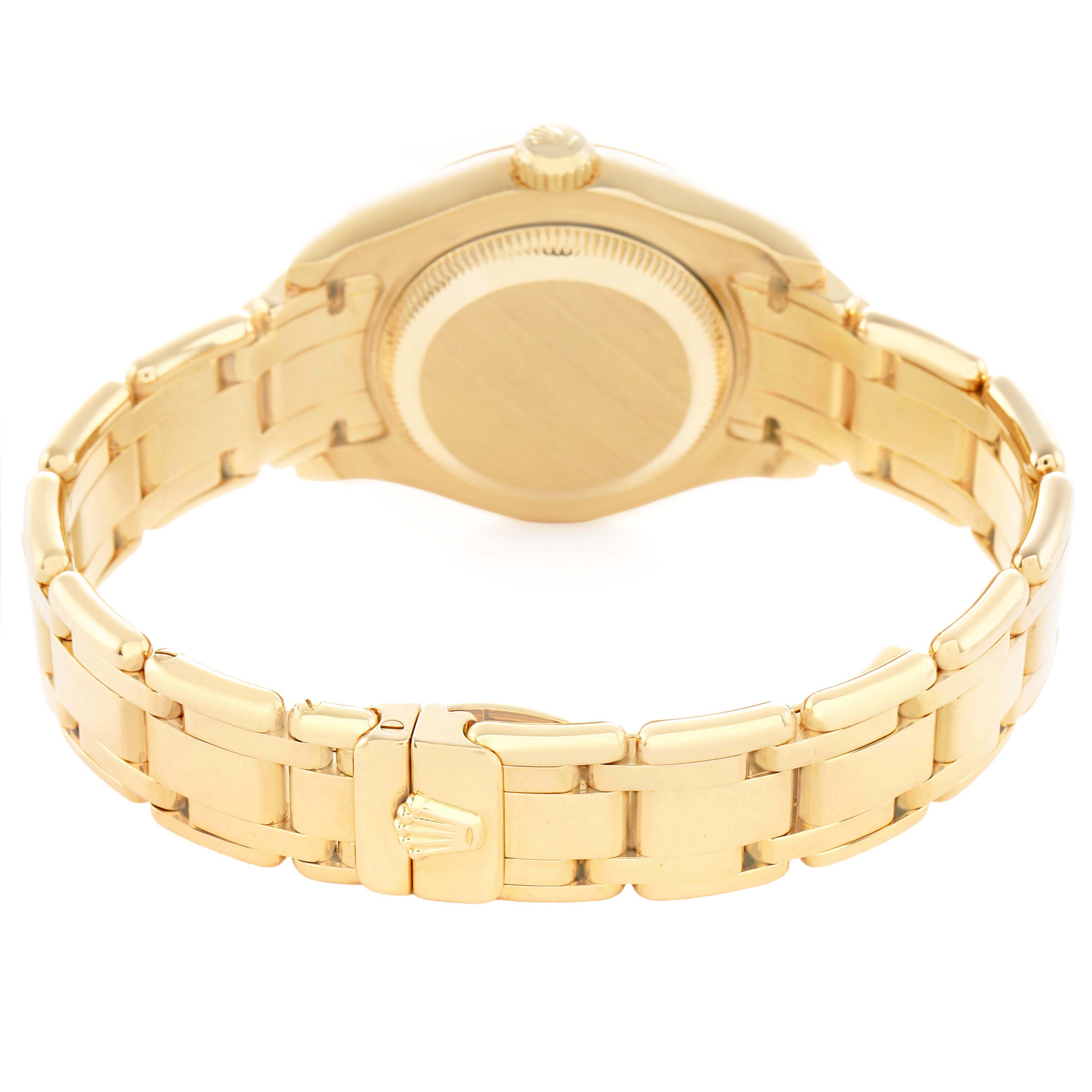 The Rolex Pearlmaster 69298 Women's Yellow Gold White Dial watch is shown from the back, highlighting the case back, bracelet, and clasp detail.