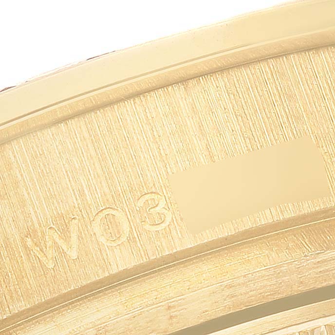 The image shows a close-up of the engraved side of a Rolex Pearlmaster 69298 Women's Yellow Gold White Dial 69298 Women's Yellow Gold White Dial watch, highlighting text and serial details.