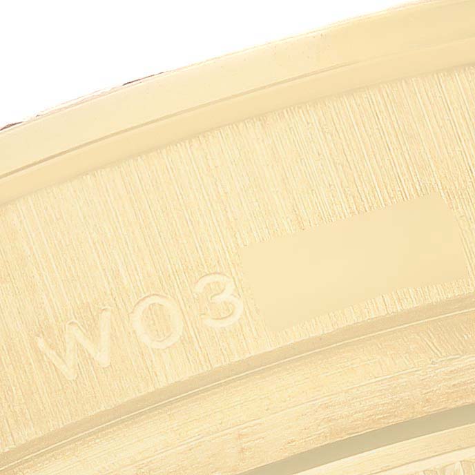 The image shows a close-up of the gold rim with markings on the Rolex Pearlmaster 69298 Women's Yellow Gold White Dial watch.