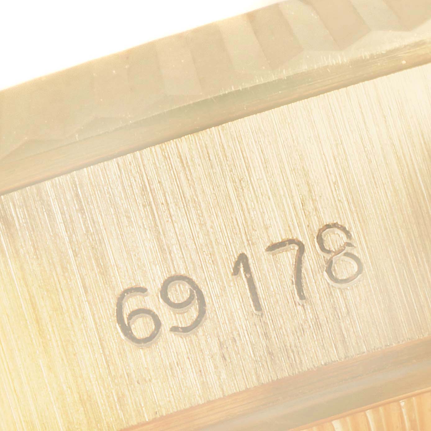 This close-up image shows part of the gold case and reference number of a Rolex President 69178 Women's Yellow Gold Champagne Dial 69178 Women's Yellow Gold Champagne Dial model watch.