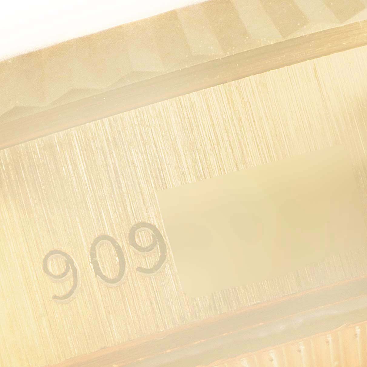 This close-up shows the engraved serial number area and part of the bezel of the Rolex President 69178 Women's Yellow Gold Champagne Dial 69178 Women's Yellow Gold Champagne Dial model watch.