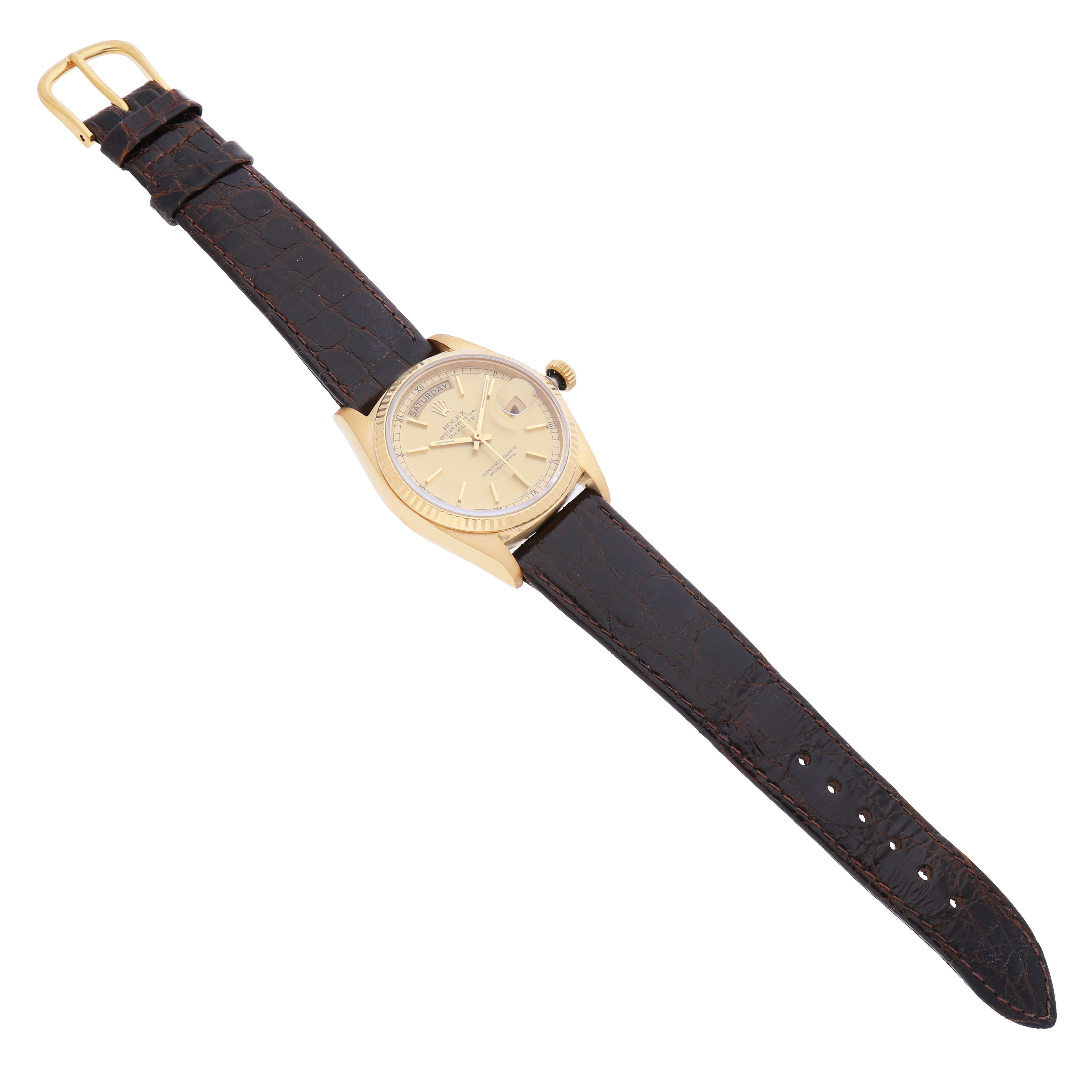 The Rolex President 18038 Men's Yellow Gold Champagne Dial watch is shown from a slightly angled top view, featuring a gold case and a brown leather strap.
