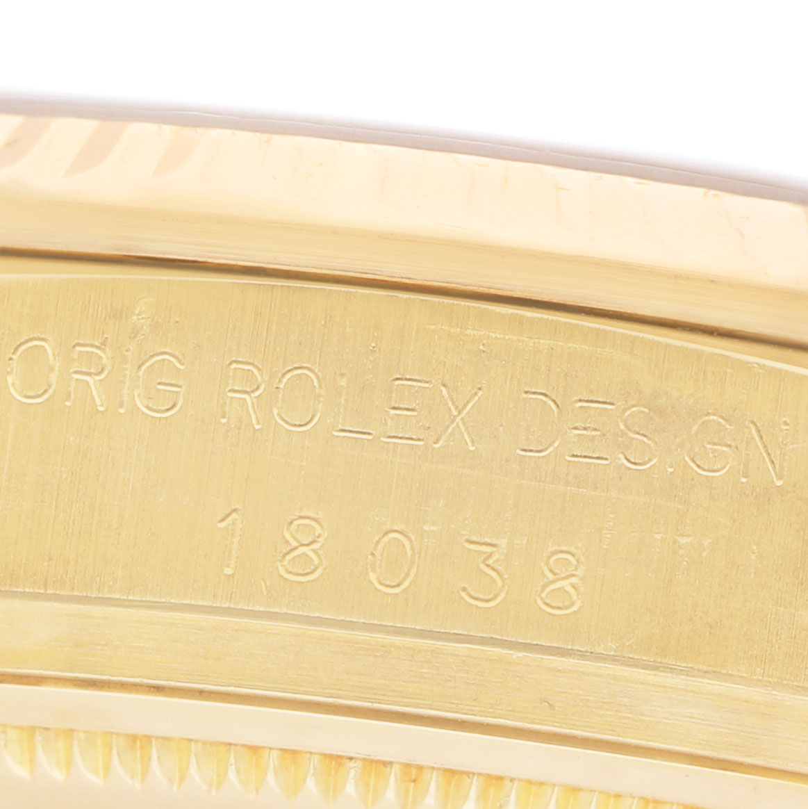 The image shows a close-up of the edge and engraving on a Rolex President 18038 Men's Yellow Gold Champagne Dial model, focusing on the reference number.