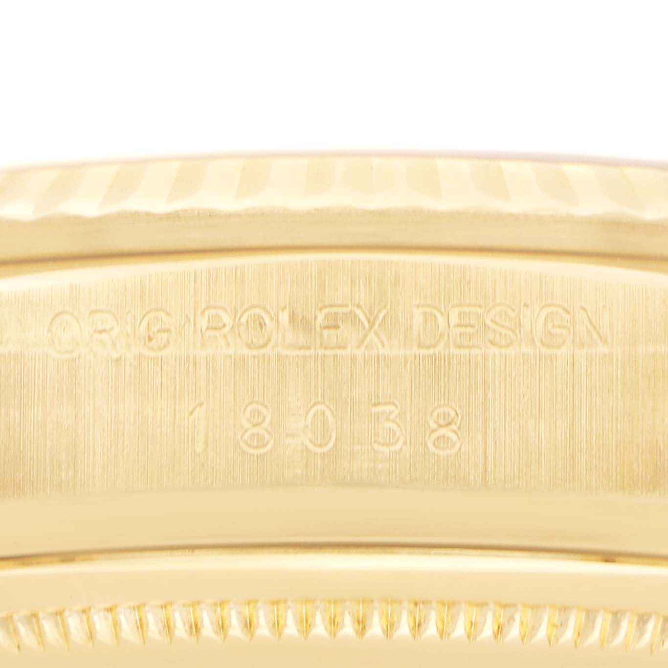 The image shows a close-up of the side of a Rolex President 18038 Men
s Yellow Gold Champagne Dial model, focusing on the engraved model and design number on the case.