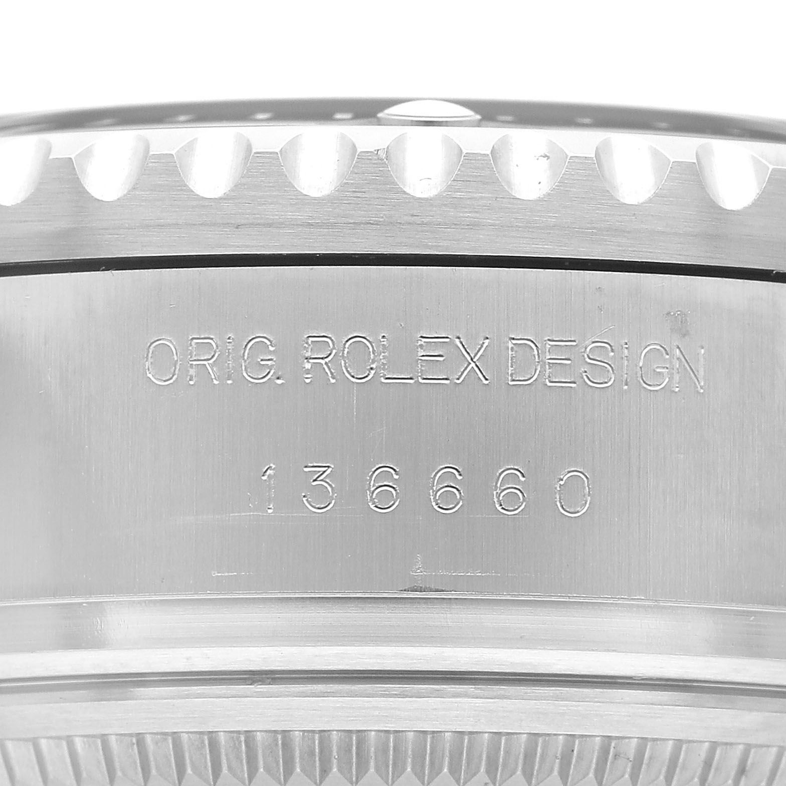 The image shows a close-up of the edge and side of a Rolex Sea-Dweller 136660 Men's Stainless Steel Black Dial, highlighting the model number engraving.