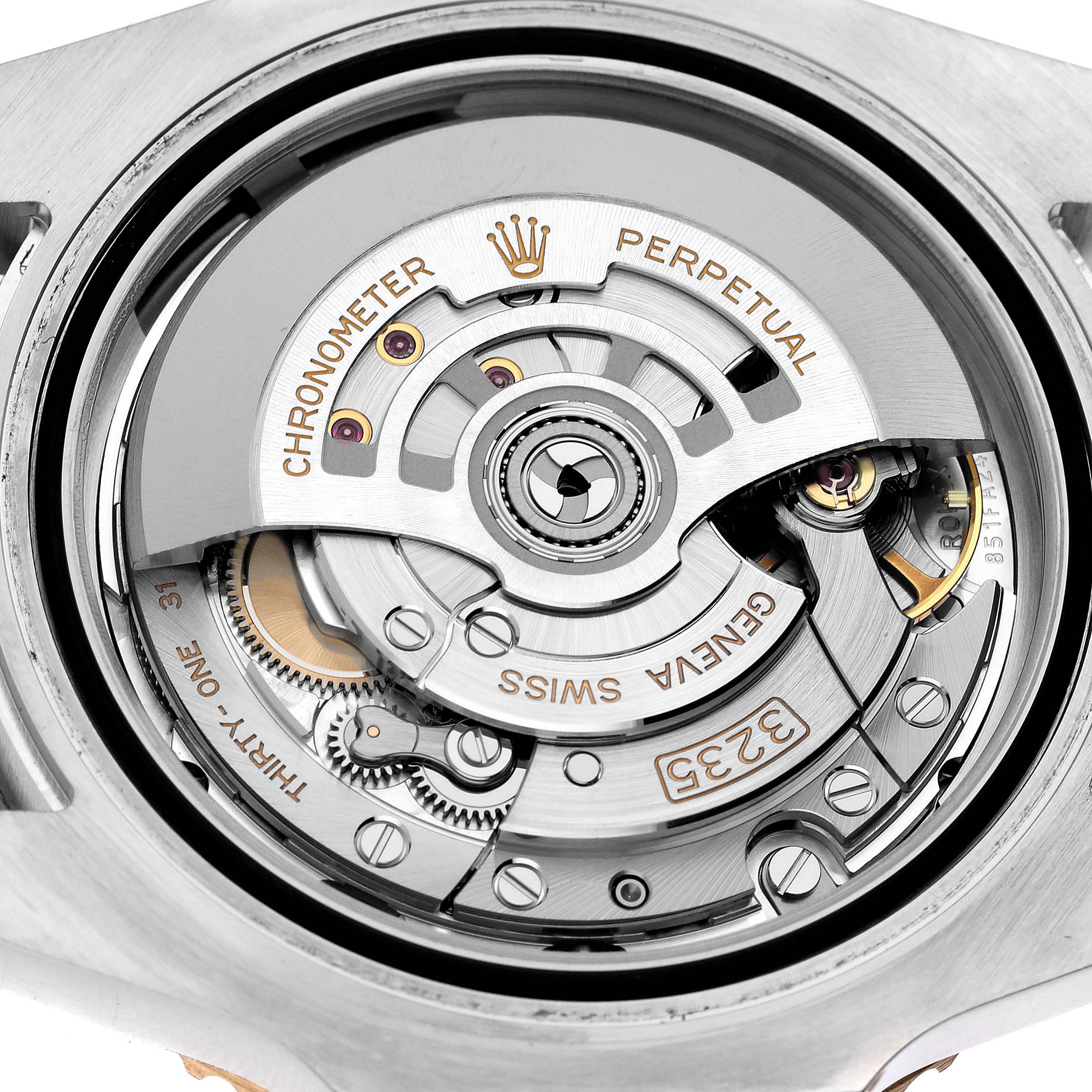 The image shows the movement of the Rolex Submariner 126613 Men's Steel and Gold (two tone) Blue Dial 126613 Men's Steel and Gold (two tone) Blue Dial from a top-down angle, highlighting its intricate internal mechanisms.