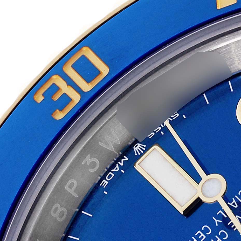 The image shows a close-up of the Rolex Submariner 126613 Men's Steel and Gold (two tone) Blue Dial 126613 Men's Steel and Gold (two tone) Blue Dial's blue bezel, part of the dial, and a watch hand.