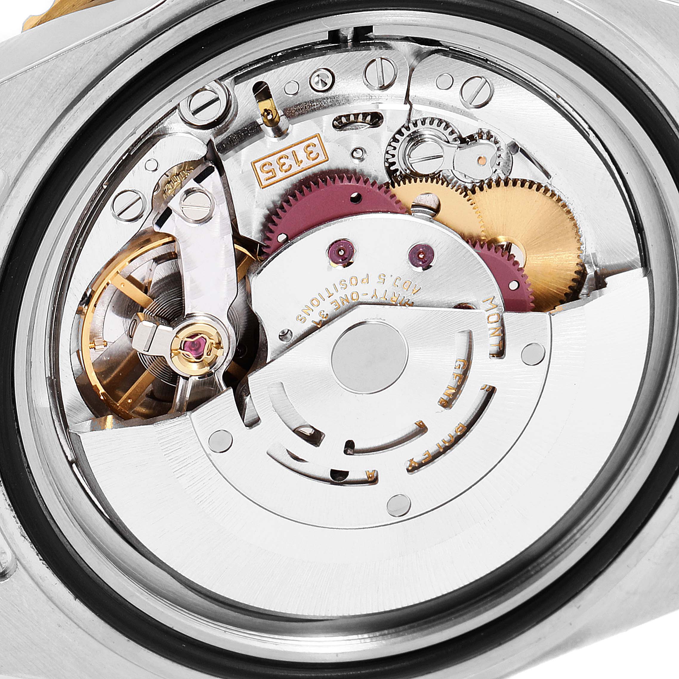 The image shows a close-up view of the internal mechanism of a Rolex Submariner 16613 Men's Steel and Gold (two tone) Black Dial 16613 Men's Steel and Gold (two tone) Black Dial watch, highlighting its intricate parts and gears.