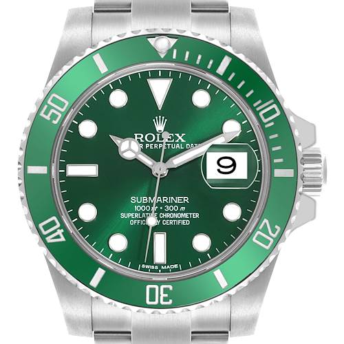 The image shows a frontal view of a Rolex Submariner, highlighting the green bezel and dial, date window, and bracelet.