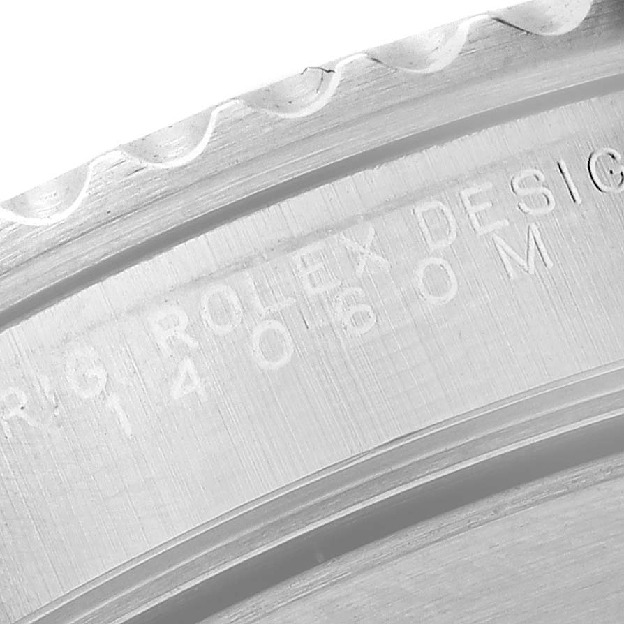 The image shows a close-up of the engraved outer rim and inner bezel of a Rolex Submariner 14060 Men
s Stainless Steel Black Dial 14060 Men
s Stainless Steel Black Dial watch.