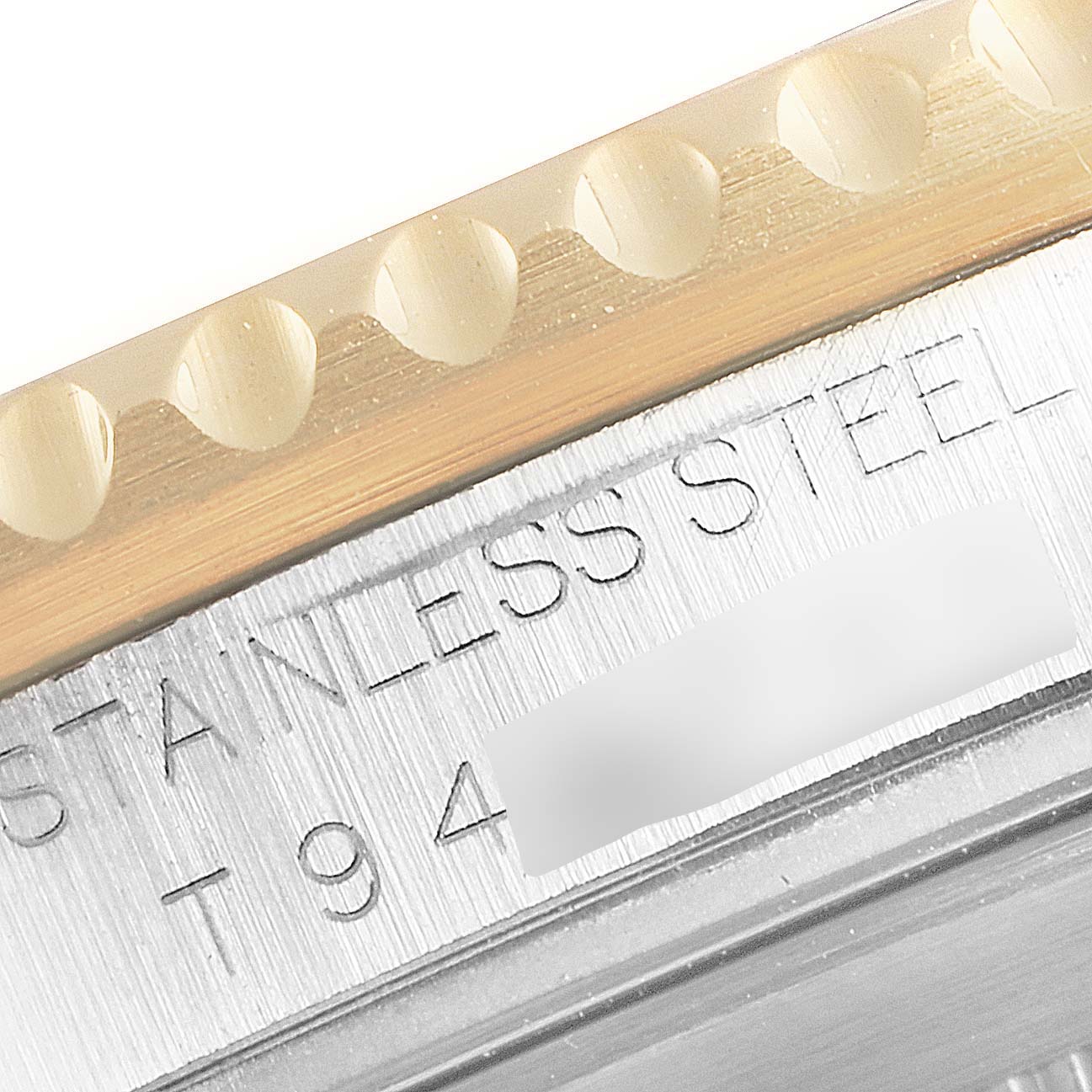 This close-up image shows the side engraving and the bezel of a Rolex Submariner 16613 Men's Steel and Gold (two tone) Blue Dial 16613 Men's Steel and Gold (two tone) Blue Dial watch.