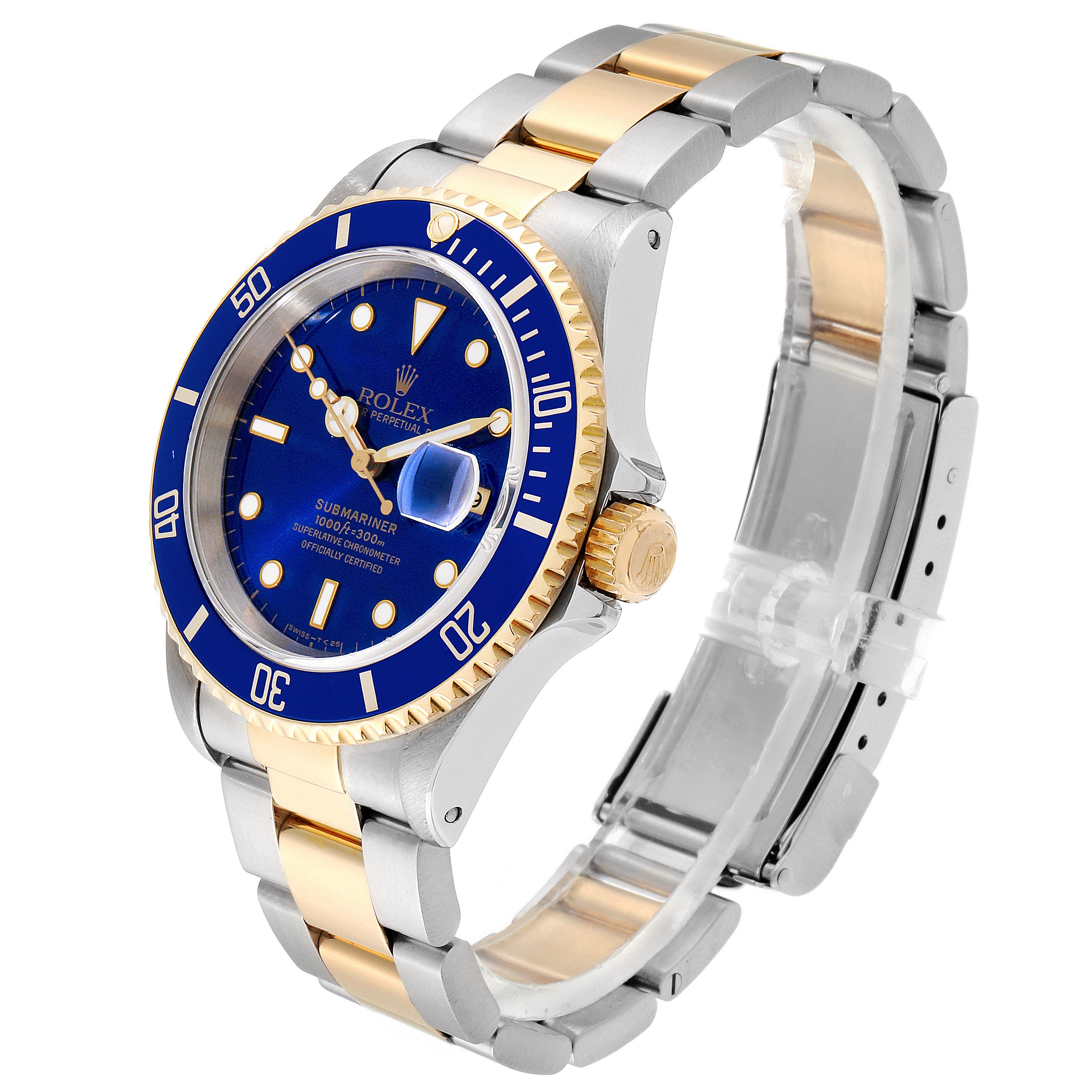 The image shows a Rolex Submariner 16613 Men's Steel and Gold (two tone) Blue Dial 16613 Men's Steel and Gold (two tone) Blue Dial watch at an angled view, highlighting its blue dial, gold bezel, and two-tone bracelet.